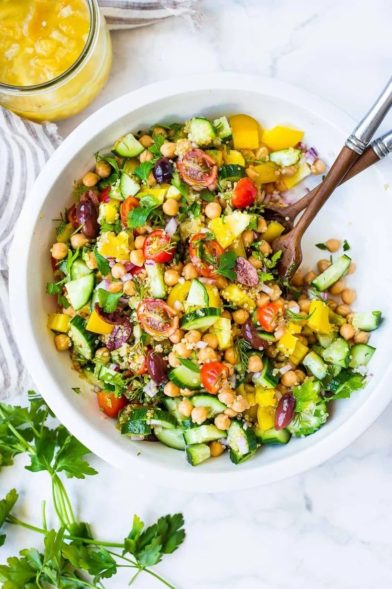 Lemon herb quinoa and chickpea bowl with fresh vegetables and lemon dressing