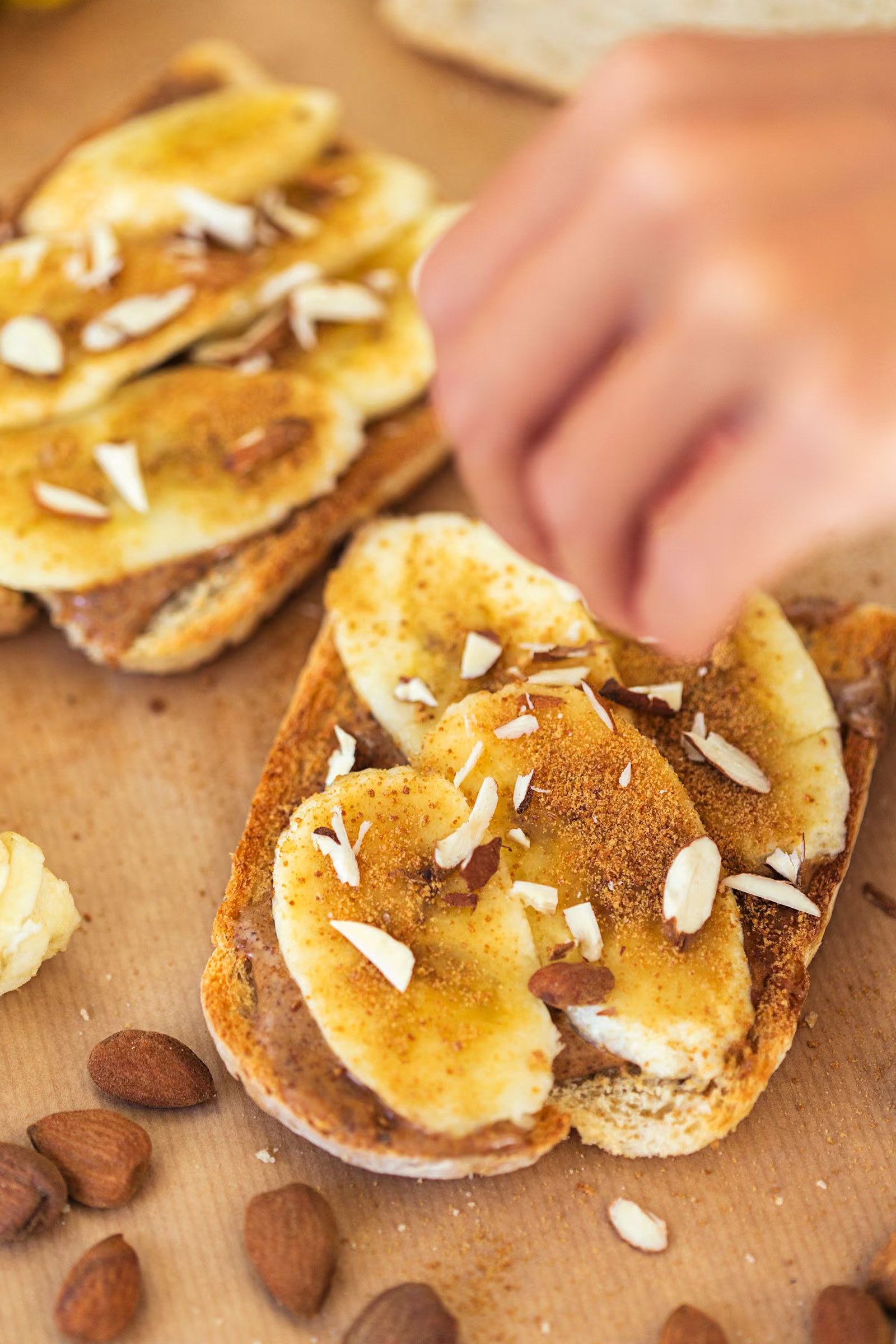 Three sweet potato toast slices including one topped with seed butter and banana