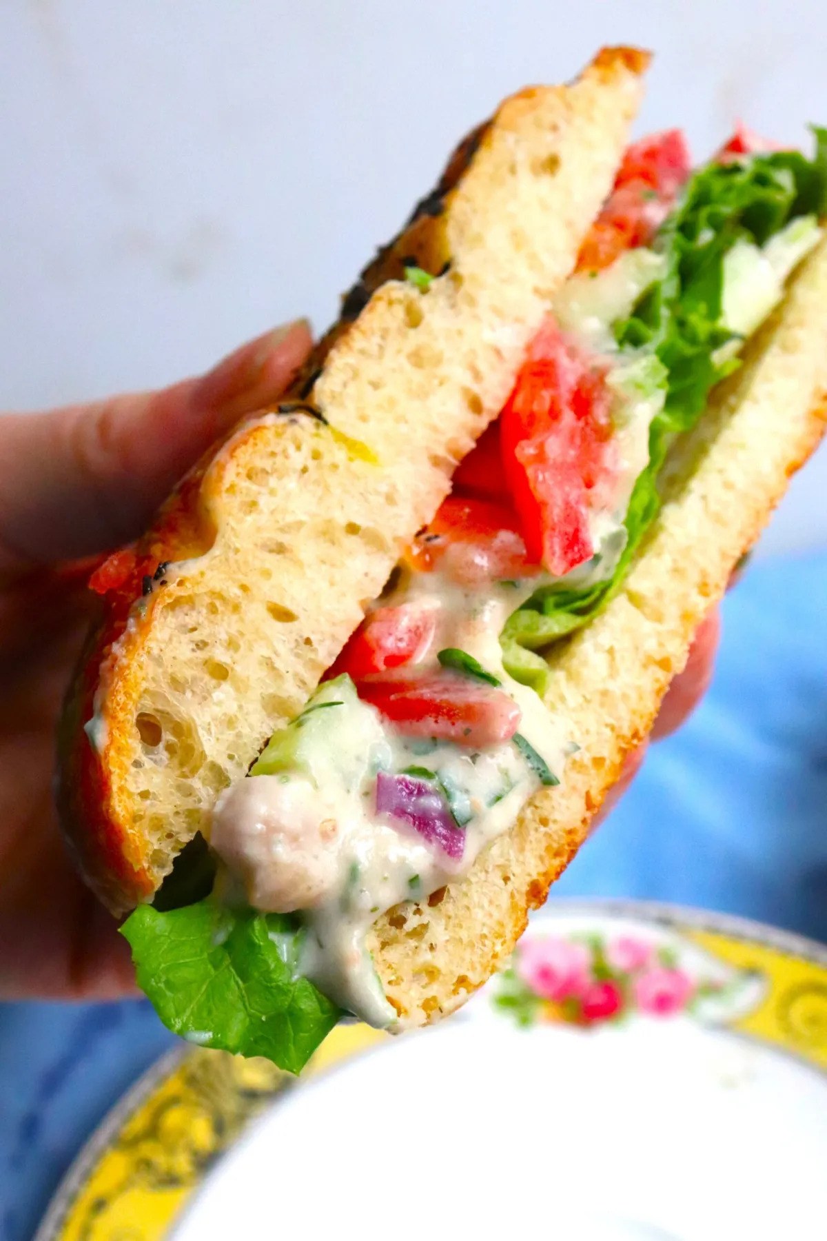 Smashed white bean and celery salad sandwich with lettuce and radish