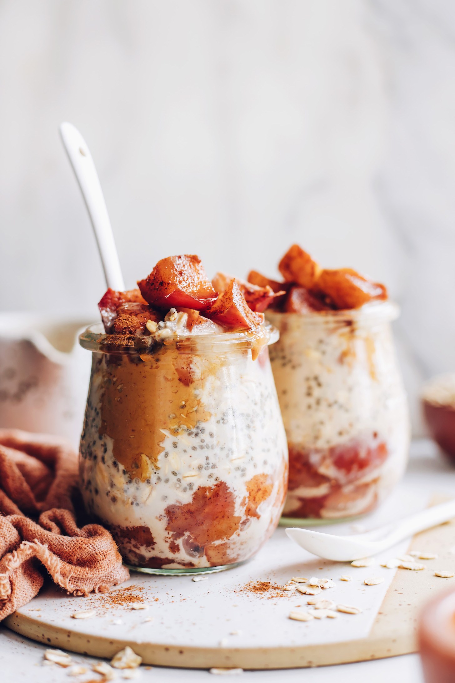 A jar or bowl of vegan overnight oats topped with berries and banana