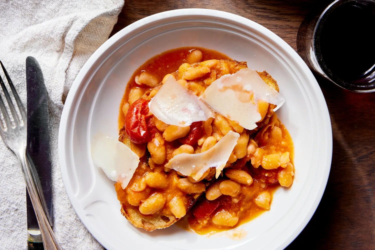 Tuscan white beans in tomato broth served over thick garlic-fried bread