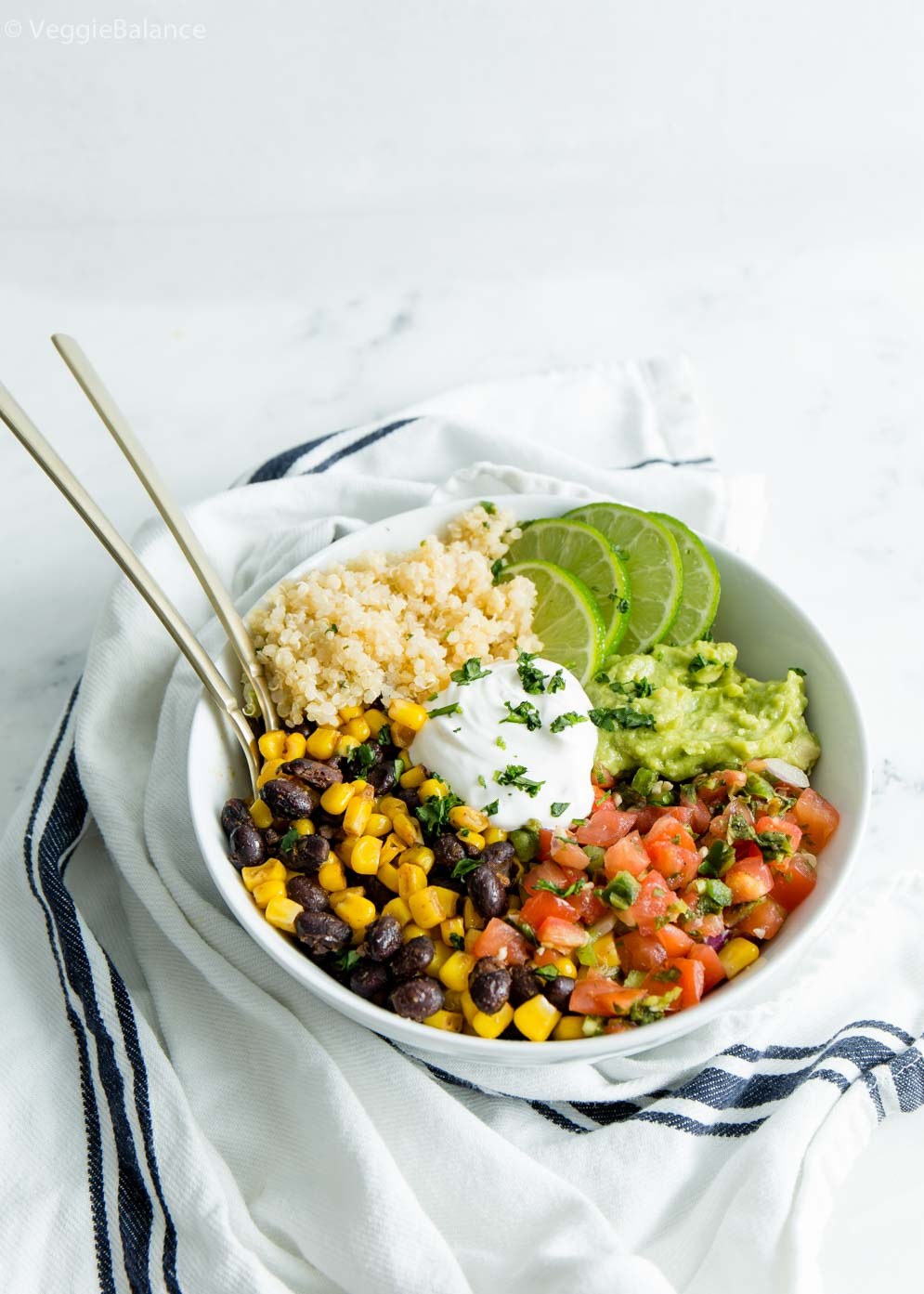 Vegan burrito bowl with spiced black beans, quinoa, lettuce and tortillas