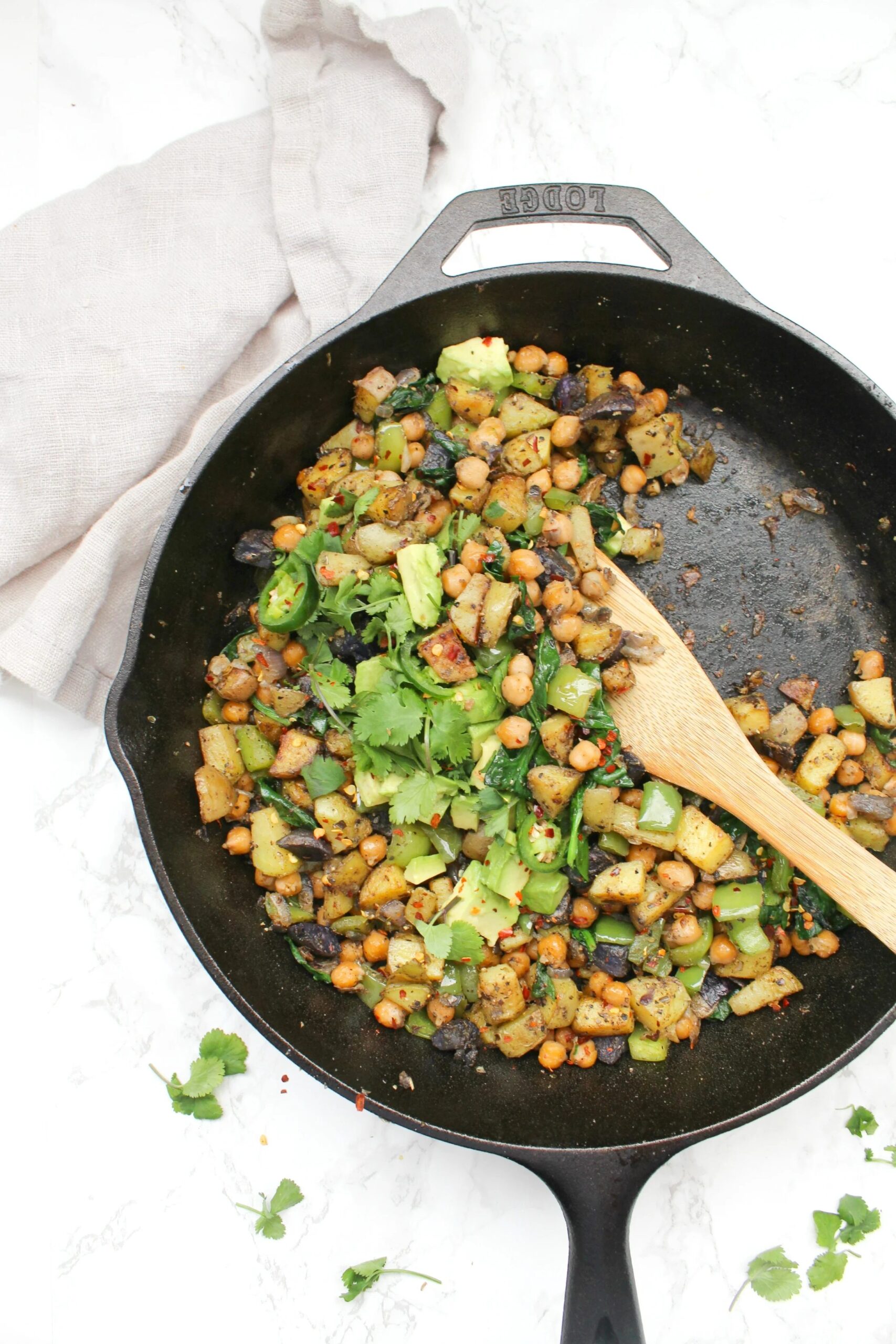 Vegan chickpea potato breakfast hash with crispy potatoes, peppers, and avocado